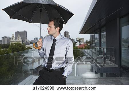 Stock Photo - Depressed man in the rain. Fotosearch
