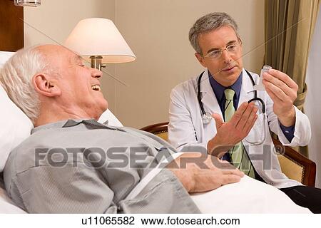 Stock Image - Doctor and his senior patient. Fotosearch