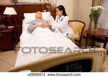 Doctor caring about patient View Large Photo Image Stock Image - Doctor caring about patient. Fotosearch