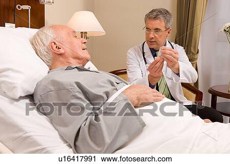 Doctor explaining about medication View Large Photo Image Stock Image - Doctor explaining about medication. Fotosearch