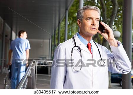 Doctor making a call View Large Photo Image Stock Photo - Doctor making a call. Fotosearch