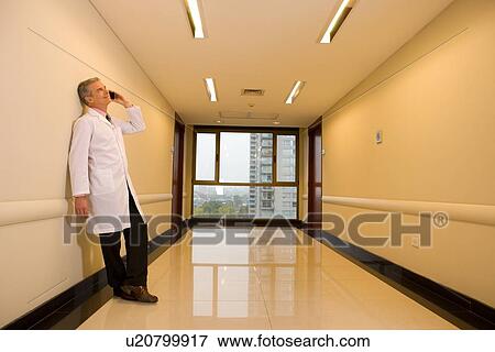 Doctor on a phone View Large Photo Image Stock Photo - Doctor on a phone. Fotosearch