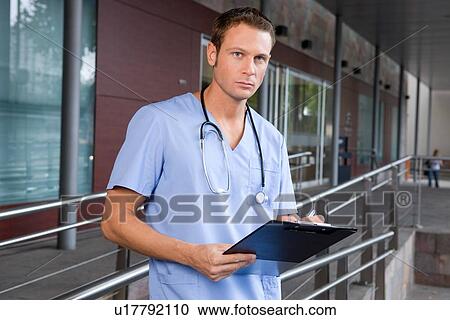 Stock Image - Doctor outside hospital. Fotosearch