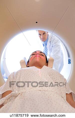 Doctor performing a tomography View Large Photo Image Stock Photo - Doctor performing a tomography. Fotosearch