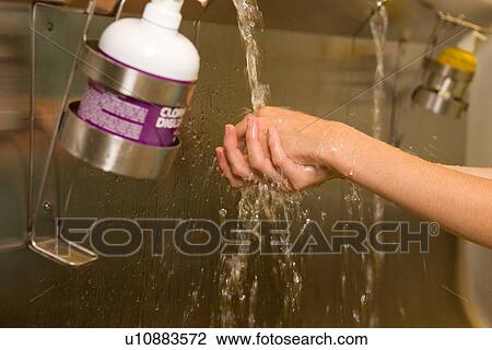 Stock Image - Doctor washing hands. Fotosearch