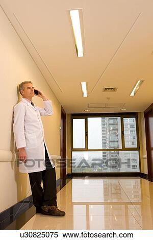 Stock Photography - Doctor with a mobile phone. Fotosearch