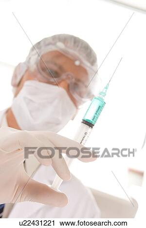 Stock Image - Doctor with a syringe. Fotosearch