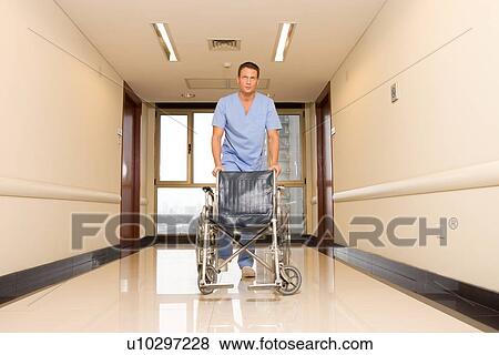 Doctor with a wheelchair View Large Photo Image Stock Photo - Doctor with a wheelchair. Fotosearch