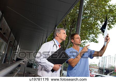 Stock Photograph - Doctors examining x-ray. Fotosearch