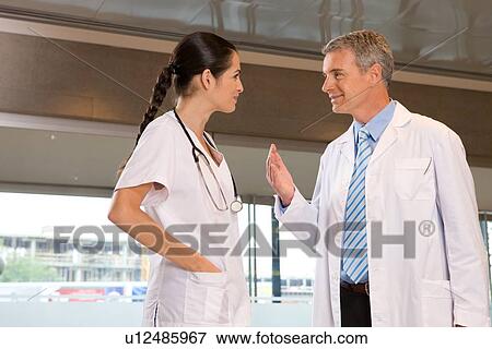 Doctors having a conversation View Large Photo Image Stock Photo - Doctors having a conversation. Fotosearch