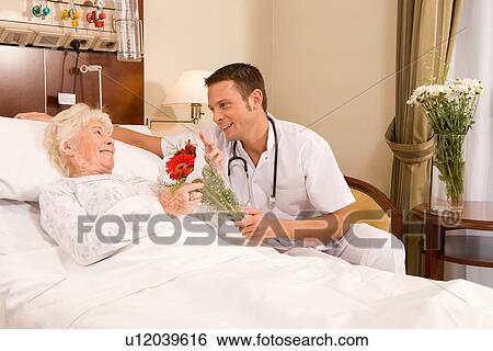 Doctors offering flowers View Large Photo Image Stock Photograph - Doctors offering flowers. Fotosearch