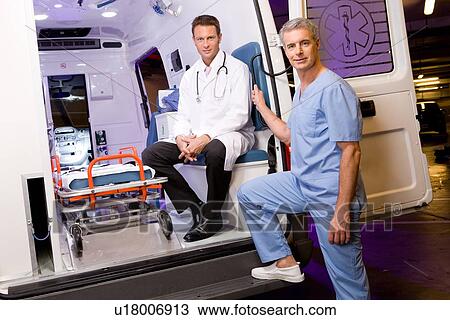 Stock Image - Doctors with an ambulance. Fotosearch