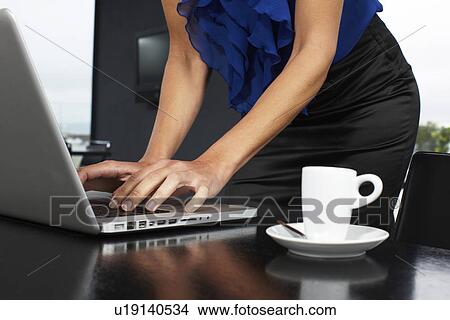 Elegant woman working with her laptop View Large Photo Image Picture - Elegant woman working with her laptop. Fotosearch