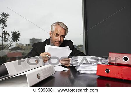 Stock Image - Executive at his desk. Fotosearch