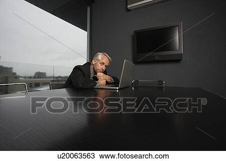 Stock Image - Executive at his luxurious office. Fotosearch