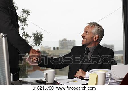 Stock Image - Executive shaking hand. Fotosearch