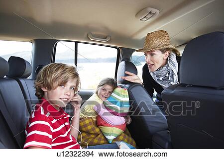 Picture - Family driving in a car. Fotosearch