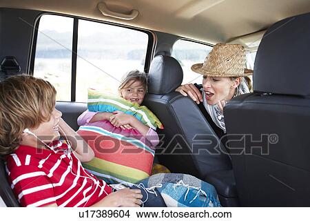 Family in a car View Large Photo Image Picture - Family in a car. Fotosearch