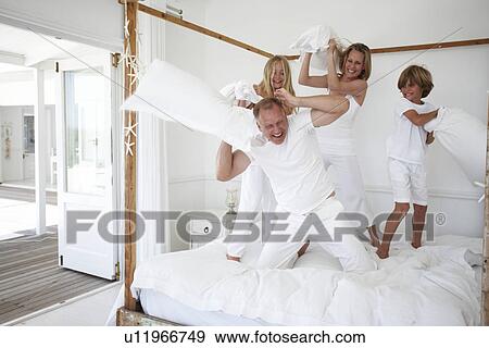 Stock Photo - Family pillow fighting. Fotosearch
