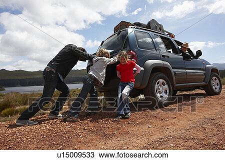 Stock Image - Family pushing broken car. Fotosearch