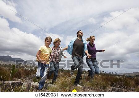 Family running in the meadow View Large Photo Image Stock Image - Family running in the meadow. Fotosearch