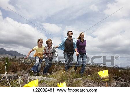 Family running in the meadow View Large Photo Image Stock Image - Family running in the meadow. Fotosearch