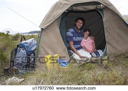 Stock Image - Father and daughter in a tent. Fotosearch