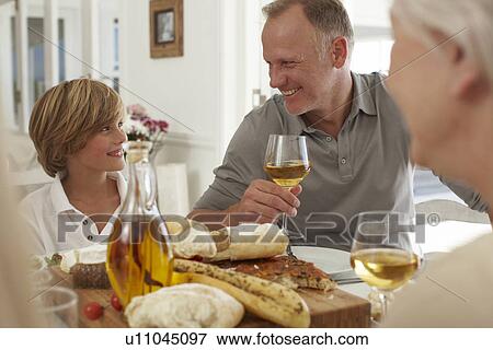Stock Photo - Father and son at a family meal. Fotosearch