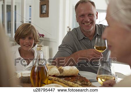 Father and son at a family meal View Large Photo Image Stock Photo - Father and son at a family meal. Fotosearch