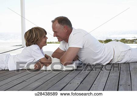 Stock Photo - Father and son close on the seaside. Fotosearch