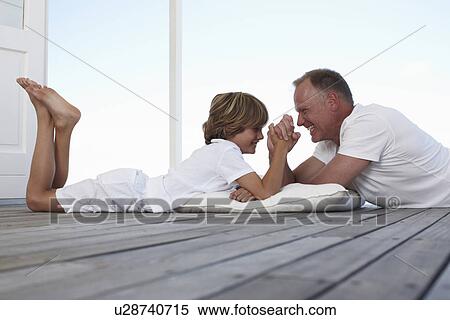 Stock Photography - Father and son competing. Fotosearch
