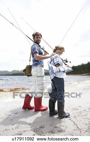 Father and son fishing at a lake View Large Photo Image Stock Image - Father and son fishing at a lake. Fotosearch