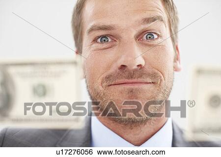 Stock Photograph - Funny man with dollars. Fotosearch