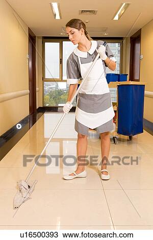 Stock Image - Girl cleaning floor. Fotosearch