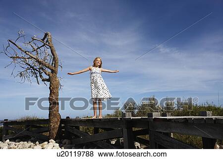 Stock Photo - Girl playing in the fields. Fotosearch