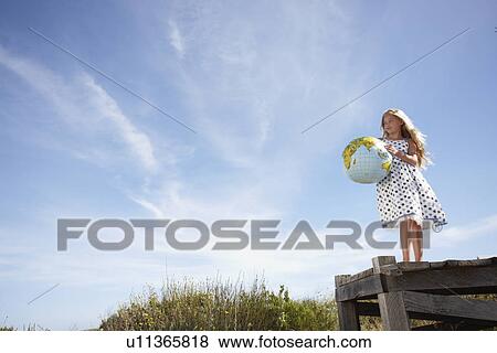 Stock Photo - Girl with a globe. Fotosearch