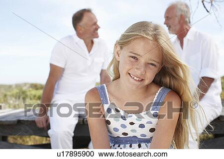 Stock Image - Girl with her father and grandfather. Fotosearch
