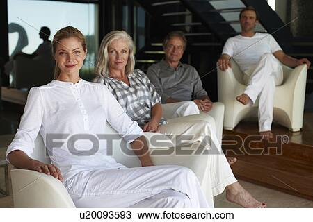 Stock Image - Group of people in a house. Fotosearch