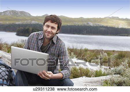 Guy with a computer View Large Photo Image Stock Photo - Guy with a computer. Fotosearch