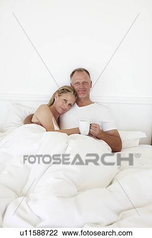 Happy couple in the bed View Large Photo Image Stock Image - Happy couple in the bed. Fotosearch
