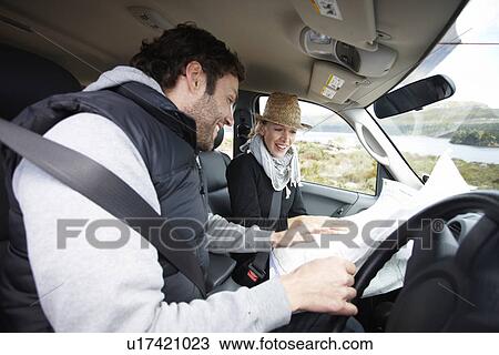 Stock Image - Happy couple in their car. Fotosearch
