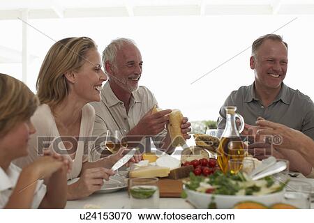 Happy family at a lunch table View Large Photo Image Stock Image - Happy family at a lunch table. Fotosearch