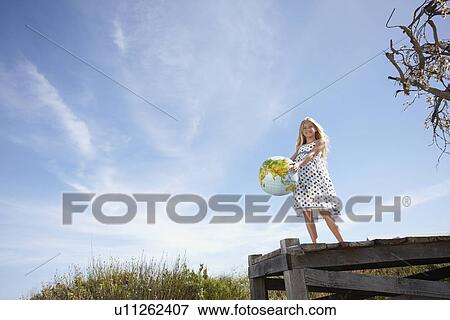 Happy girl with a globe View Large Photo Image Stock Photo - Happy girl with a globe. Fotosearch
