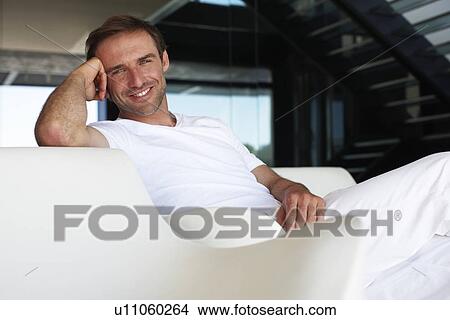 Picture - Happy man in his house. Fotosearch