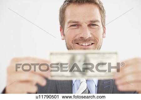 Stock Image - Happy man with a banknote. Fotosearch