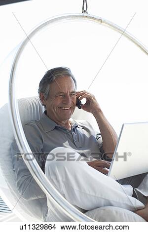 Happy senior with a computer View Large Photo Image Picture - Happy senior with a computer. Fotosearch