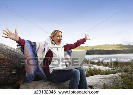 Happy woman with a computer View Large Photo Image Stock Photography - Happy woman with a computer. Fotosearch