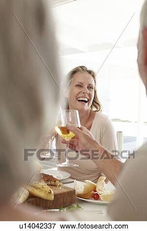 Happy woman with a glass of wine View Large Photo Image Stock Photo - Happy woman with a glass of wine. Fotosearch