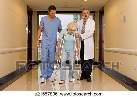Helping an old lady to walk View Large Photo Image Stock Photograph - Helping an old lady to walk. Fotosearch