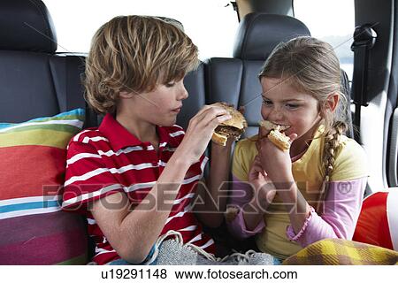 Stock Photo - Kids eating a hamburger. Fotosearch